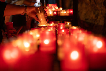A person is pouring wax into a candle Enol lakes in covadonga asturias