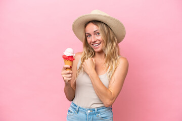 Young Russian woman holding an ice cream isolated on pink background celebrating a victory