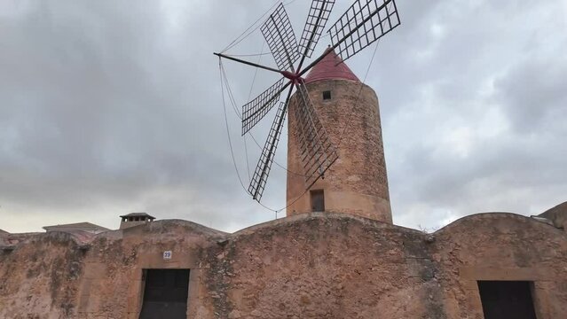 Windmill in Algaida, traditional architecture with dramatic sky. Balearic island of Mallorca, Spain