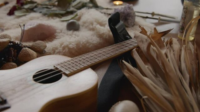A guitar laying on the ground as part of a meditative shrine