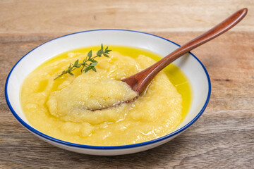 Polenta or grits or mamaliga in ceramic bowl.