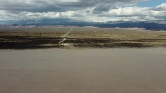 Long road from Argentina mountains to flat sandy Arroyo El Leoncito