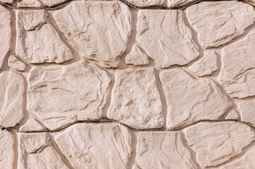 Background, texture of the wall made of uneven stone tiles.