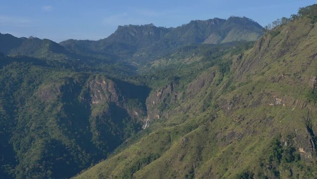 Slow motion landscape view of mountain range cliffs hills with vegetation nature sunrise Little Adam`s Peak Ella Sri Lanka Asia travel tourism hiking