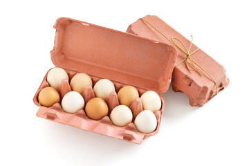 Brown, white eggs in carton