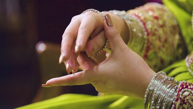 A lovely Balochi bride from Pakistan donning her stunning silver bracelet, close-up shot.