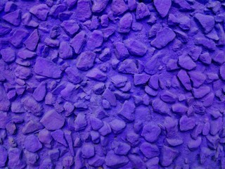 Violet painted stone wall or fence texture background. Beautiful purple gravel pattern. Textured...