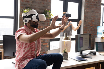 A diverse team, including an Asian male, explores virtual reality in a modern office
