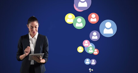 Image of Caucasian woman using tablet over social icons floating on blue background