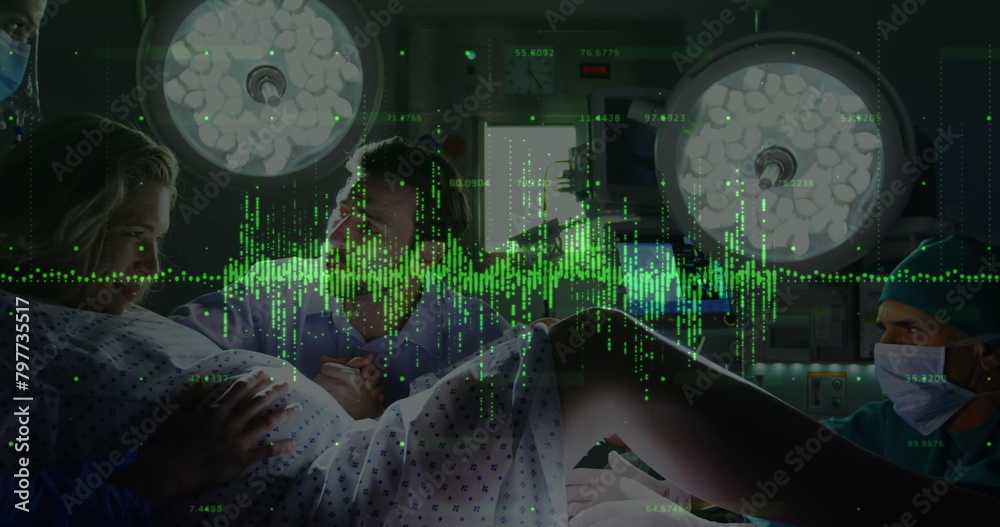 Poster Digital image of financial data processing against woman giving birth in labor room at hospital