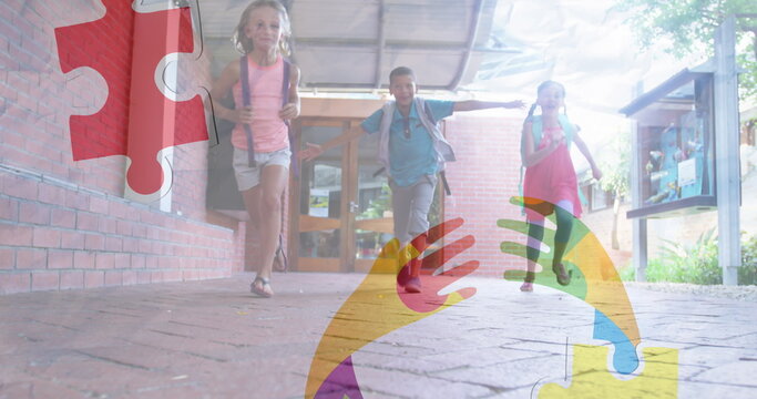 Image of puzzles falling over ribbon formed with puzzles and school children running in school - Powered by Adobe