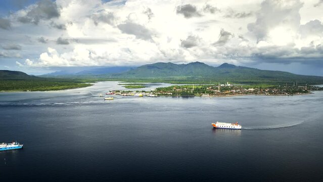 Boats navigate strong current at Gilimanuk ferry port, Bali. Drone hyperlapse