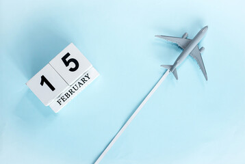 February calendar with number  15. Top view of calendar with flying passenger plane. Scheduler....