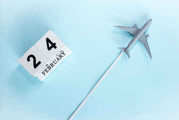 February calendar with number  24. Top view of calendar with flying passenger plane. Scheduler....