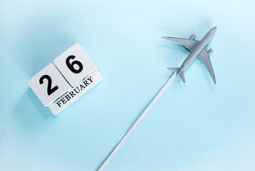 February calendar with number  26. Top view of calendar with flying passenger plane. Scheduler....