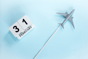February calendar with number  31. Top view of calendar with flying passenger plane. Scheduler....