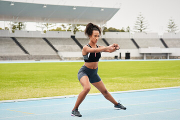 Woman, athlete and stretching on track field for running, training and fitness in summer....