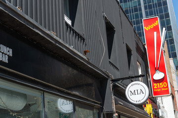 Fototapeta premium exterior building and projecting sign at MIA Brunch Bar and Juicy Dumpling located at 2140 and 2150 Yonge Street in Toronto, Canada