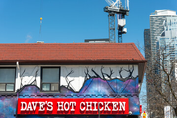 Fototapeta premium exterior building and sign of Dave's Hot Chicken, a chicken restaurant chain, located here at 2066 Yonge Street in Toronto, Canada