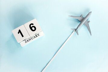 January calendar with number  16. Top view of a calendar with a flying passenger plane. Planner for the year by date of the day. Copy space.