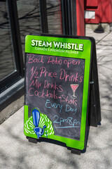 Fototapeta premium sidewalk chalkboard outside a pub in Toronto, Canada (Steam Whistle branded)