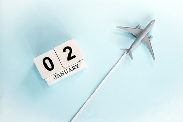 January calendar with number  2. Top view of a calendar with a flying passenger plane. Planner for the year by date of the day. Copy space.