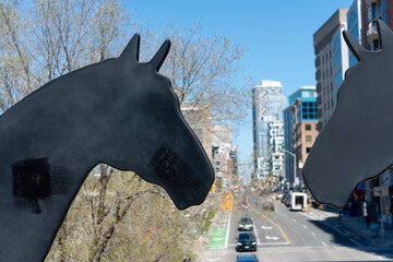 Fototapeta premium public sculpture called The Iron Horse by Robert Sprachman located on bridge along Kay Gardner Beltline Trail in Toronto, Canada - looking north on Yonge St