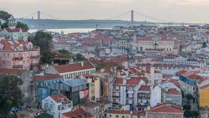 Fototapeta na wymiar Lisbon panorama after sunset aerial view of city centre with red roofs at autumn day to night timelapse, Portugal