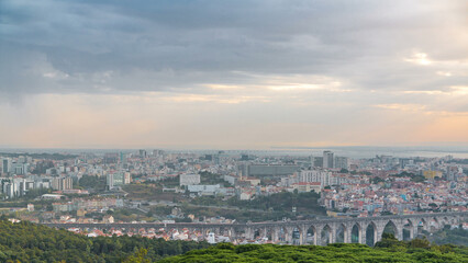 Panoramic overview during sunrise over Lisbon and Almada from a viewpoint in Monsanto morning timelapse.