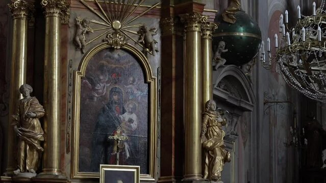 Painting of Jesus and Mary set in a golden frame on the wall of the Roman Catholic church of St. Anne in Warsaw Poland