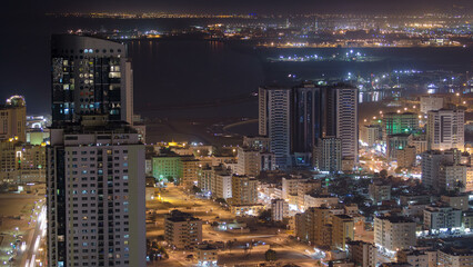 Cityscape of Ajman from rooftop night aerial timelapse