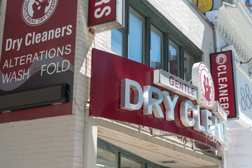 Obraz premium multiple signs outside Gentle Beau Dry Cleaners located at 891 Yonge Street in Toronto, Canada