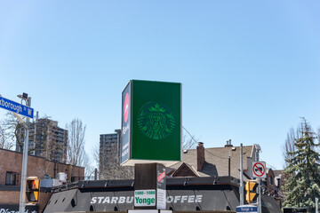 Obraz premium bizarre green washed Starbucks Mermaid logo and former location sign at 1088 Yonge Street in Toronto, Canada
