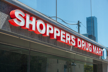 Obraz premium Shoppers Drug Mart logo and sign outside a location in Toronto, Canada