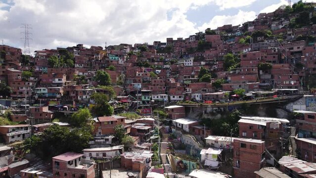 Hillside patchwork of colorful homes in Medellin's Comuna 13, Colombia - aerial