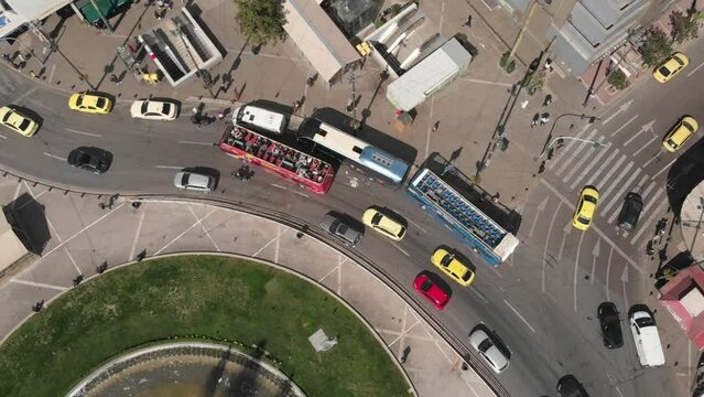 Aerial perspective on a roundabout with a big fountain in the middle in the city center of Athens (Drone Footage)
