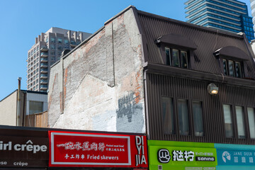 Naklejka premium ghost outline and construction residue on building side along Yonge Street in downtown Toronto, Canada (and also site of businesses including Diyijia, Pokéwave, and Jane Deer Desserts)