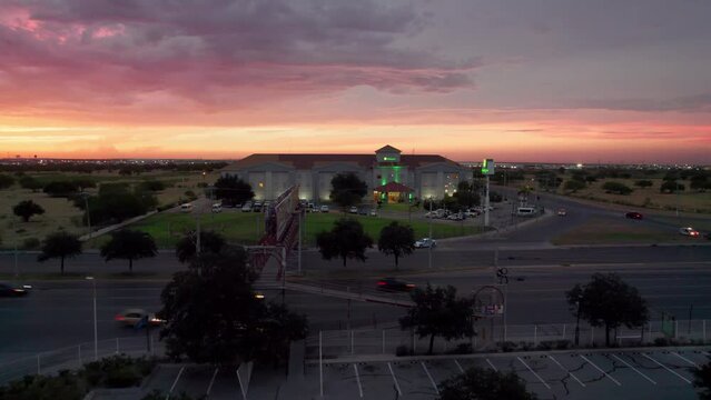 Drone image of a sunset over a bustling shopping mall and busy avenue in Reynosa, Mexico.
