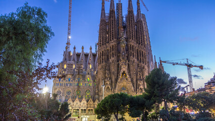 Sagrada Familia, a large church in Barcelona, Spain day to night timelapse.