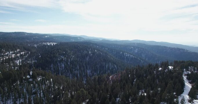 Aerial view flying over a snow covered mountain in the New Mexico Rocky Mountains