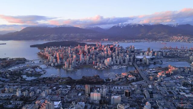 Aerial footage of the urban cityscape of Vancouver at sunset with in British Columbia, Canada