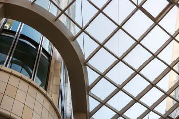 Obraz premium glancing up at the semi-open metal lattice ceiling with transparent panels, spanning the walkway of the shopping complex located at The Well (486 Front Street West in Toronto, Canada)