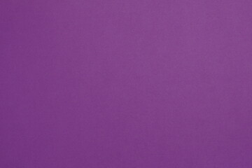 Photo of sheet of bright violet cardboard paper with smooth surface background