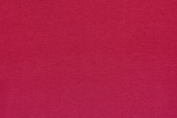 Closeup of magenta cotton jersey plain fabric with stitches texture
