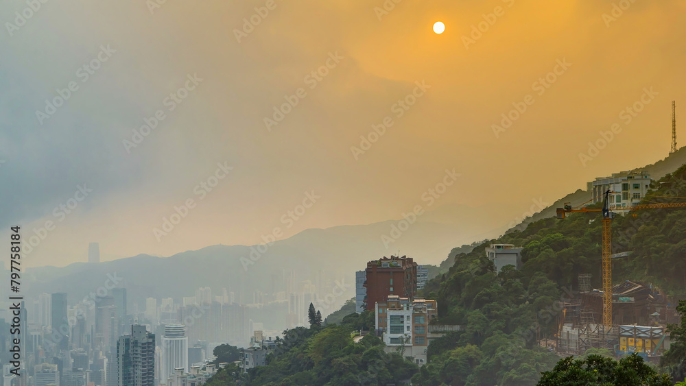 Wall mural the famous view of hong kong from victoria peak timelapse. taken at sunrise while the sun climbs ove