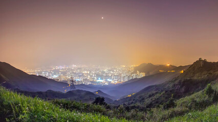 Cityscape of Hong Kong as viewed atop Kowloon Peak night timelapse with Hong kong and Kowloon below - obrazy, fototapety, plakaty