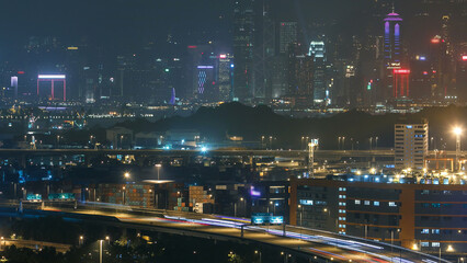 Fototapeta na wymiar Hong Kong Skyline and Container Terminal in port at night timelapse