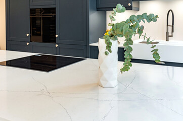 Close-up photo of decorations on white marble counter top in new kitchen