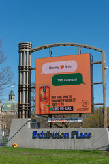 Obraz premium playful and cheeky: a modern twist on peachy advertising (simply peach alcoholic beverage ad on LED billboard at Exhibition Place in Toronto, Canada)