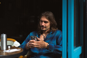 A long-haired man has breakfast at a street cafe in Istanbul.